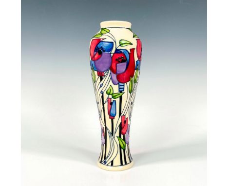 Extravagant tall vessel featuring tube-line decorations of stylized tulips and lattice work, set against a cream colored grou