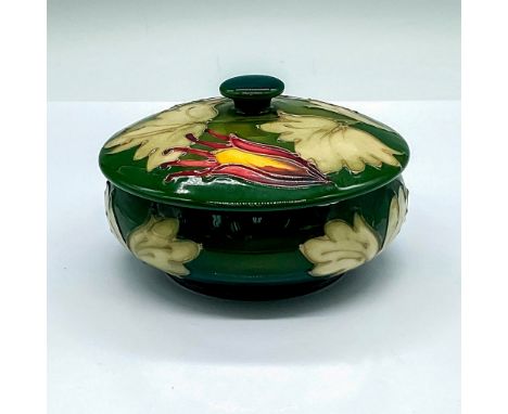 A beautiful green glazed round box adorned in stunning yellow and purple flowers with excellent tube lining. Moorcroft marked