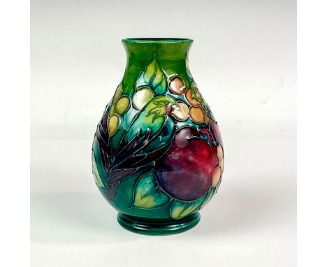 Superb vessel of baluster form, decorated with birds pecking at fruits and berries on a green ground; glaze interior. Moorcro