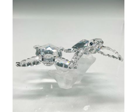 Part of the Aquatic Worlds family grouping. Clear crystal faceted body and flippers with aqua crystal eyes swimming above a s