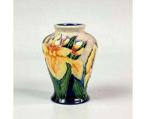 A beautiful vessel decorated with tube line yellow iris flowers and their foliage on a blue and cream ground; glaze interior.