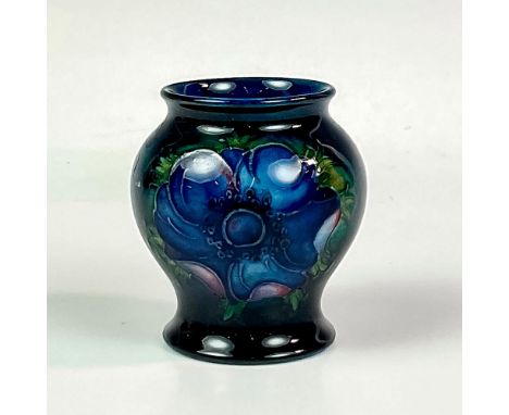 A small, exquisite vessel featuring tube line anemone flowers on a rich blue ground. W Moorcroft Potter To H. M. Queen Mary l