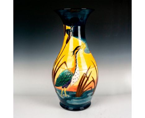 A delightful vessel, tube-line decorated with a heron before a sunset landscape, reserved against a dark cobalt blue filed. B