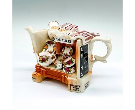 A white and brown decorative teapot molded to imitate a shop cart with a mini tea set, basin, plate, and vase in Old Country 