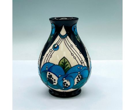 A small black and white glazed vase with stylized blue roses. Moorcroft marking and artist's marking on the base. This item h