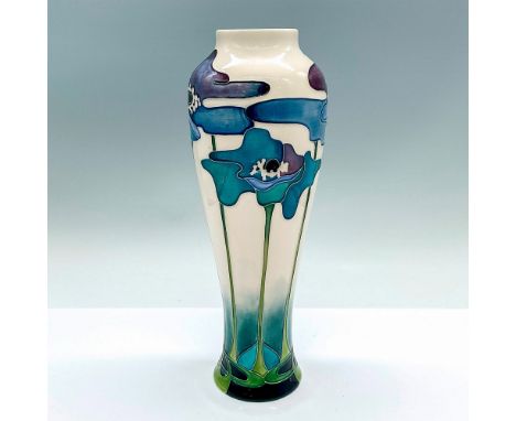 A beautiful vase adorned in blue Art Deco style flowers. Moorcroft mark and artist's marking on the base. This item has its o