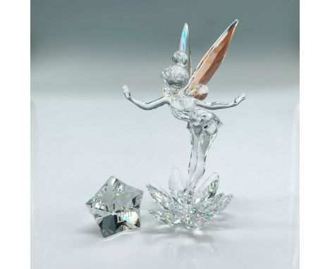 Faceted and smooth crystal figure of Tinkerbell standing in the middle of a lotus flower. Her wings shimmer in a Crystal Auro