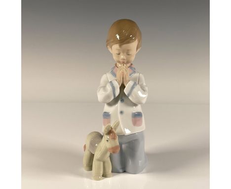 Glossy finish; little boy wearing his pj's prays before bedtime. Lladro backstamp. This item has its original box. Box measur