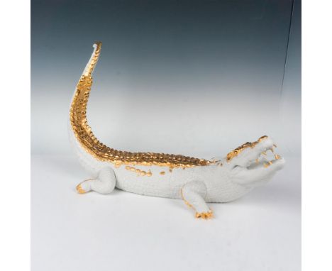 A magnificent limited edition sculpted white matte reptile with glistening touches of gold colored luster to scales, claws, a