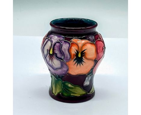 A small glazed vase with a maroon exterior and dark cyan interior. Decorated in a pink, purple, and orange pansy pattern. Moo