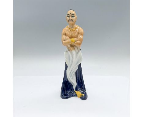 A hand painted and hand made figure of a genie emerging from the lamp. Royal Doulton backstamp. Artist: Robert TabbenorIssued