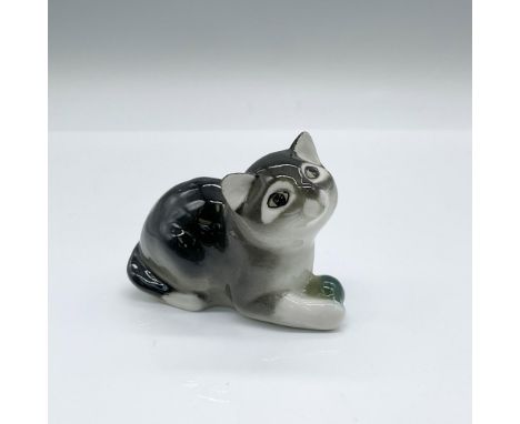 A vintage glazed figure of a black, gray, and white kitten holding a green ball. Lomonosov backstamp. Issued: 1940sDimensions
