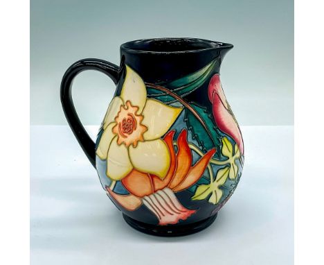 A cobalt glazed Queen Elizabeth II commemorative jug adorned with flowers and stunning detailed tube lining. Moorcroft and ar