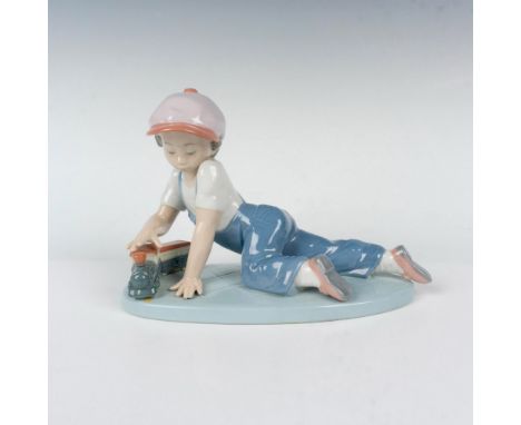 Glossy finish; young boy in overalls plays with his toy train. 1992 Collectors Society figure. Lladro backstamp. This item ha