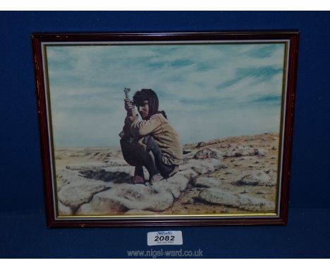 A small framed Print by John Tidewell depicting an Omani soldier.