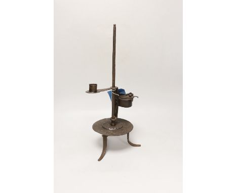 An 18th century Continental iron adjustable candle holder incorporating a crusie lamp, 41cm