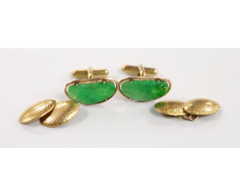 A pair of Chinese yellow metal mounted carved green jade cufflinks, 23mm, together with a further pair of planished yellow me