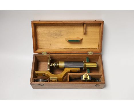 A lacquered brass field microscope, in fitted case, case 26cm wide