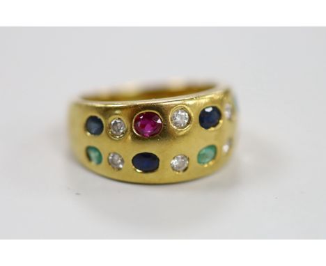 A modern 750 and gypsy set two row, ruby, emerald, sapphire and diamond half hoop ring, size K, gross weight 7.6 grams.