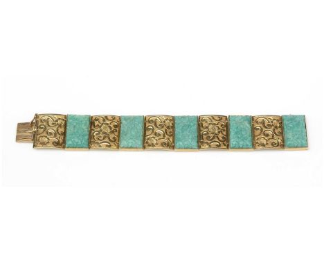 A green stone and 14ct yellow gold bracelet, the five jade-style stone plaques carved with floral design alternating between 