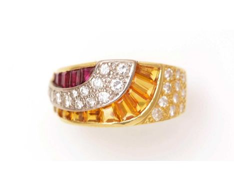 A ruby, yellow-sapphire and diamond dress ring, set with graduated baguette and shaped step cut rubies and sapphires, surroun