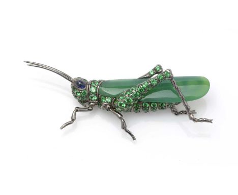A fine jade, tsavorite garnet and sapphire grasshopper brooch, the jade wing surrounded by circular facet-cut garnets to body