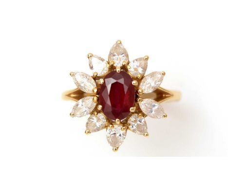 A ruby and diamond cluster ring, the oval facet-cut ruby surrounded by four marquise-cut diamonds and six pear-cut diamonds, 