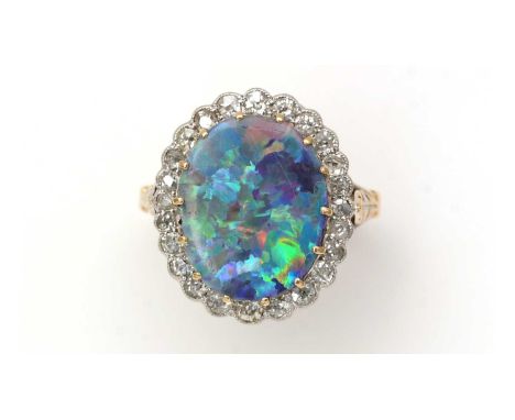 An opal doublet and diamond cluster ring, the oval opal doublet measuring 15.1 x 11.7mm surrounded by twenty-four graduated e