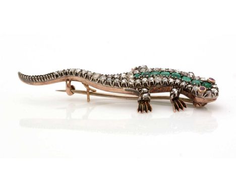 A Victorian emerald and diamond lizard pattern brooch, set with ruby eyes, eight graduated rectangular step-cut emeralds surr