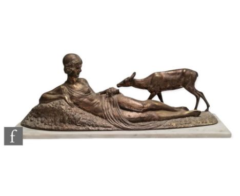 A patinated bronze figure of a reclining woman feeding a deer, signed in the cast D.H. Chiparus, set on a white marble plinth