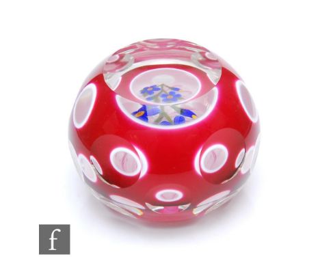 A contemporary John Deacons encased double overlay glass paperweight, internally decorated with a spray of blue flowers over 
