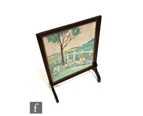 A 1930s oak framed fire screen, with embroidered panel depicting a garden scene with hills to the distance, height 78cm and w