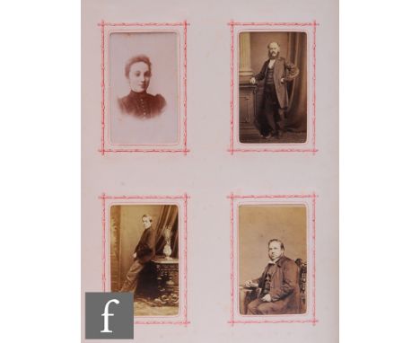 A Victorian family photograph album containing various sized black and white images, the front board with marquetry design of