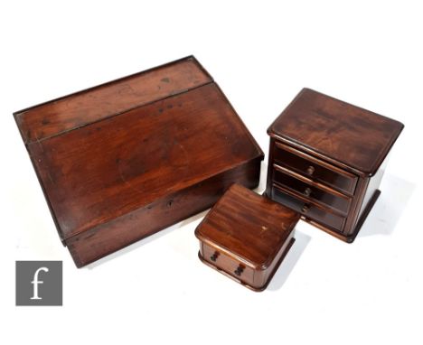 A 19th Century walnut lap desk the interior fitted with a bank of pigeonholes, raised gallery back, width 57cm, and two trink