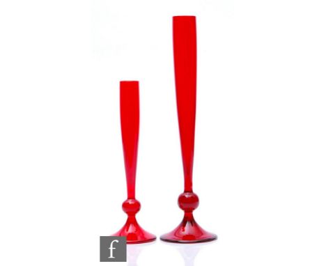 A graduated pair of Whitefriars shape 9485 bud vases in ruby, the slender swollen sleeve form body above a large ball knop an