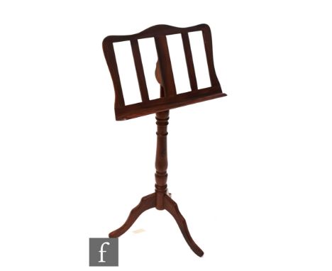 A Victorian style walnut music stand on tripod base, height 110cm. 
