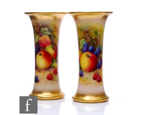 A mirrored pair of Royal Worcester Fallen Fruits lily vases, panel decorated by Lockyer with hand painted apples, black grape