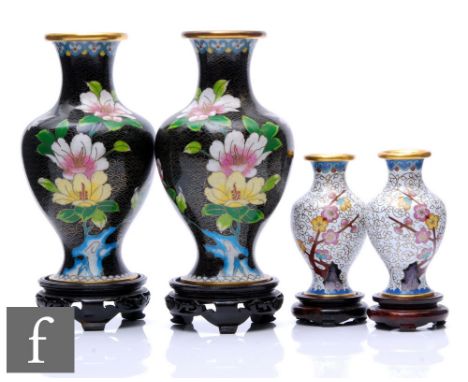 A collection of Chinese cloisonne vases, to include a black pair detailed with gilt ruyi scroll borders and ground and furthe