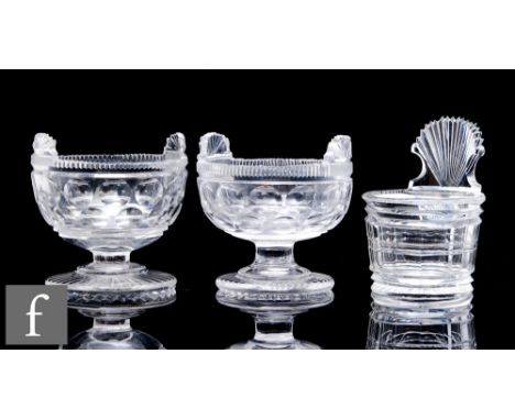 A pair of small early 19th Century clear crystal salts, the ovoid bowls with a band of printie cuts below a fan and notched c