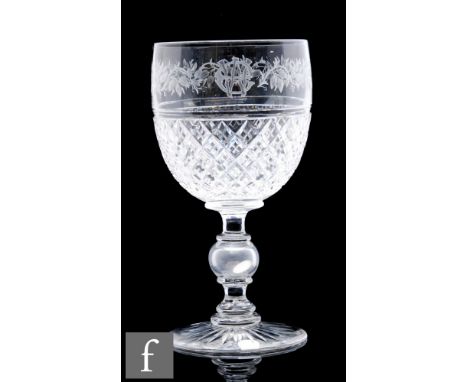 A large 19th Century clear crystal goblet, the ovoid bowl decorated with an floral polished cut border before a panel of cros