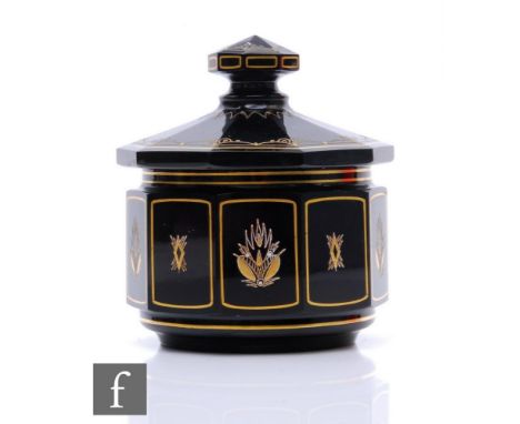 A 1920s Art Deco Moser trinket box and cover of faceted form with a matched knopped cover, decorated with small abstract pane