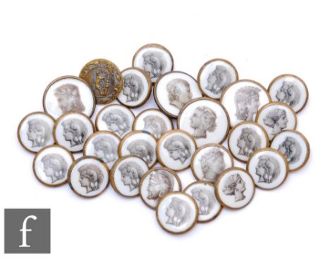 A collection of 19th Century brass backed buttons in two sizes inset with a white enamel and each with a classical Romanesque