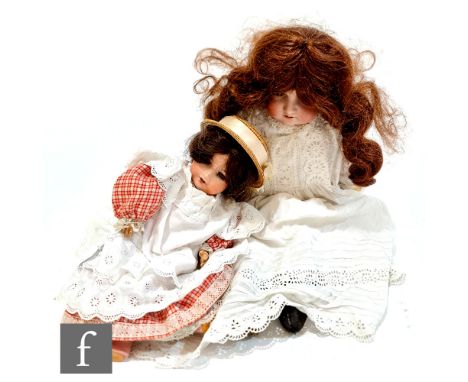 Two Armand Marseille bisque head dolls, a shoulder head doll with sleeping brown eyes, open mouth with four teeth, later brun