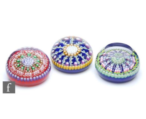 A Perthshire glass paperweight of domed form, internally decorated with three concentric circles of star canes in white and a