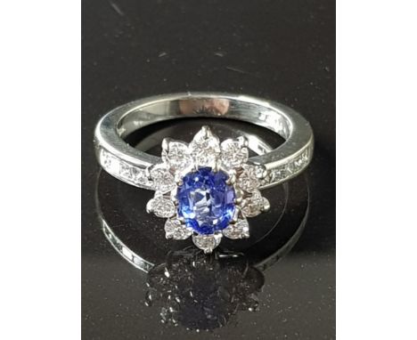 BOODLES SAPPHIRE AND DIAMOND HALO RING SET IN 18CT WHITE GOLD HALO OF BRILLIANT CUT DIAMONDS TOTAL 1CT WITH A FURTHER 0.30CT 