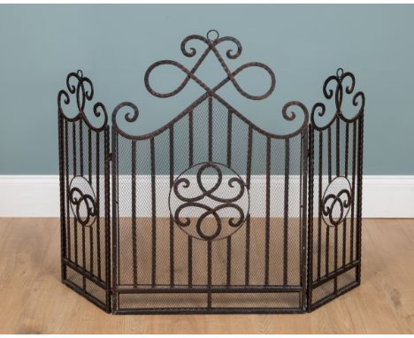 A three-section fireguard With scrolling ornament.59cm wide across the front (116cm wide fully extended) x 89cm highQty: 1In 
