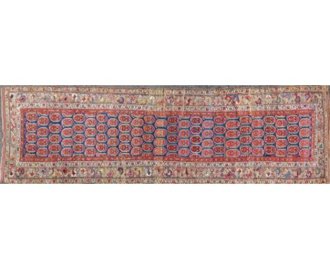 A 19th century Kurdish runner With an all-over repeating Qum pattern on a blue ground with a guarded border.366cm x 119cmQty: