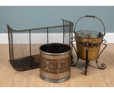 Two antique coal buckets and a low nursery fender One coal bucket with bands of copper flowers on a silvered ground; the seco