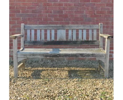 A teak garden bench With shaped arms.150cm x 82cmQty: 1Some light cracking in the wood notable particularly at the tops of th