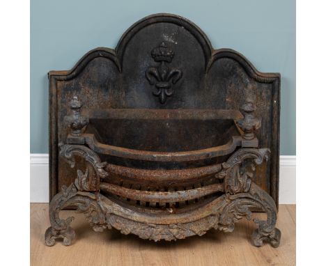 A cast iron fire grate and fireback The fire grate with urn finials and a bow front raised on scrolling legs; the fire back w